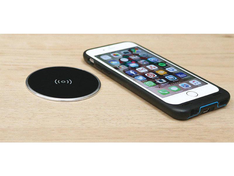 Recessed wireless surface charger with black top and silver rim, supplied with UK USB plug